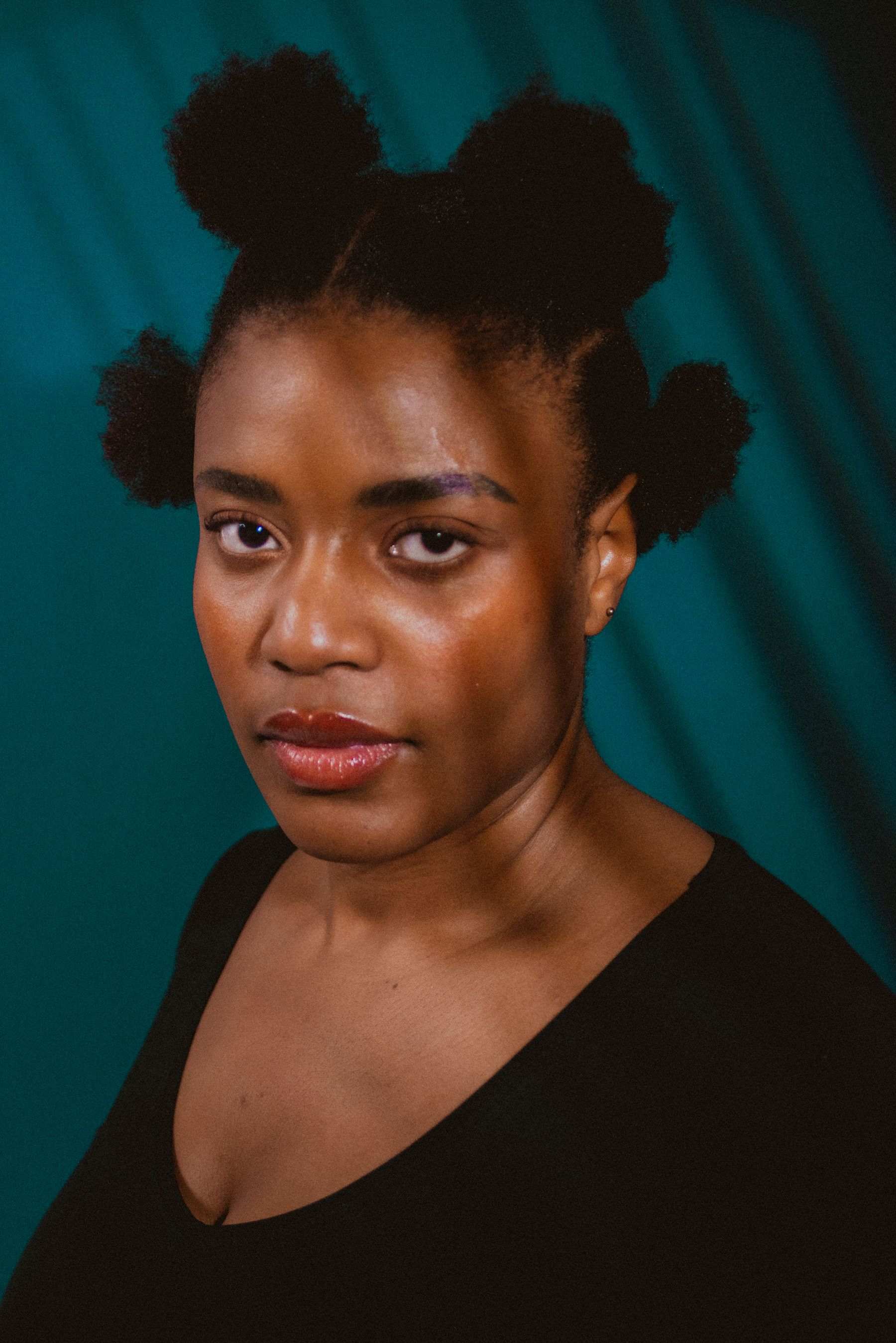 Natural hair parted into four afro puffs